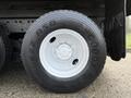 A close-up view of a black Goodyear G622 RSD tire mounted on a white rim with six bolt holes