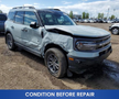 A 2023 Ford Bronco Sport with significant front damage showing a crumpled hood and fender on the driver’s side
