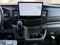 Interior view of a 2022 Ford Transit showing the dashboard with a touchscreen display and gear shifter