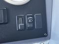 Control panel featuring three switches including a rectangular switch and two round switches for an Emergency One Fire Truck