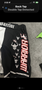 Black MMA shorts with "Warrior" printed in bold red letters along with skull and warrior graphics in white and red