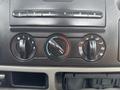 A close-up of the climate control panel in a 2006 Ford F-450 featuring three dials for temperature and airflow settings