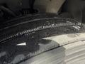 Close-up of a wet tire on a 2012 Volvo VNL showing tread patterns and grooves