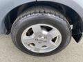 A close-up view of a silver alloy wheel from a 2006 Land Rover LR3 featuring a tire with visible tread patterns