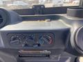 A close-up of the dashboard of a 2018 Kubota RTV-X 1100 C featuring various dials and controls for climate and engine settings