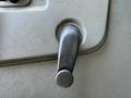 Close-up of a manual window crank handle inside a 2019 Chevrolet Express vehicle