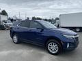 A 2022 Chevrolet Equinox in dark blue with five-spoke alloy wheels parked at an outdoor location