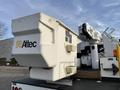 A 2013 International Durastar 4300 bucket truck featuring an Altec equipment storage box attached to the boom arm