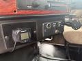 The image shows the dashboard of a 2007 Freightliner FLD120 featuring controls for the stereo and heater along with a digital gauge and a switch panel