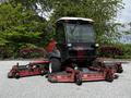 A 2012 Toro Groundsmaster with a cab and four rotary mowing decks attached, designed for maintaining large grassy areas