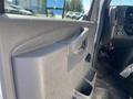 Interior view of a 2020 Chevrolet Express showing the door panel with a handle and storage compartment