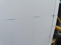 2020 Chevrolet Express van with a smooth white exterior showing a blue scratch along the side body panel