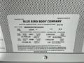 A plaque detailing specifications and manufacturing information for a 2022 Blue Bird BB Conventional bus including weight and dimensions
