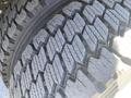 Close-up of the tread pattern on a tire of a 2015 Ford F-450 SD showing deep grooves and ridges designed for traction