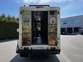 A 2009 Morgan Olson Workhorse with an open rear door displaying various storage compartments and a spacious interior design