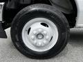 The image features a close-up of a white tire from a 2021 Ford E-450 with six lug nuts and a distinctive tread pattern on the black rubber surface