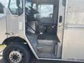A 2007 Morgan Olson Workhorse W42 with an open entryway showing the driver's seat and metal steps leading up into the cab