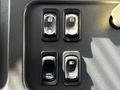 Close-up of control buttons on a 2012 Freightliner M2 106 dashboard including lock unlock and mirror heat switches