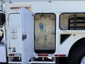 A 2008 International 7500 truck with an open side compartment revealing a clean, empty interior with blue markings on the wall and no visible shelves or equipment inside