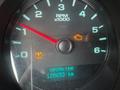 A close-up view of a 2013 Chevrolet Silverado 1500 dashboard showing the RPM gauge and warning lights with an odometer reading of 120653 km