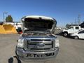 A 2014 Ford F-350 SD with its hood open showcasing the engine compartment and chrome grille