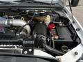 The image shows the engine compartment of a 2007 Ford F-550 featuring a large air intake system a battery and various engine components visible