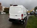 A white 2020 Ford Transit van seen from the rear with a tall body and large cargo space