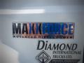 A chrome emblem displaying "MAXXFORCE" in bold blue and orange letters with the words "ADVANCED DIESEL POWER" underneath, along with an emblem for Diamond International Trucks Ltd