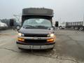 A 2017 Chevrolet Express van with a black exterior and large windshield showing headlights and front grille