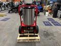 2024 Magnum 4000 Hot Water Pressure Washer on a wooden pallet featuring a large stainless steel tank and red frame with wheels