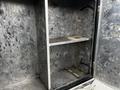 A 2007 Ford F-550 truck with a metallic utility box featuring two shelves and an open door revealing the empty interior