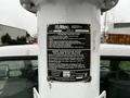 2004 Ford F-450 SD with an Altec aerial lift and safety instruction label prominently displayed on the lift arm