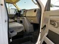 A 2017 Ford Econoline with gray interior featuring two front seats and a dashboard with controls and storage compartments