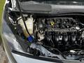 A 2016 Ford Transit Connect with an open hood revealing the engine compartment and various components including the engine block and coolant reservoir