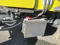 A metal battery compartment with red and silver terminals connected to a Kubota F3990 tractor's electrical system