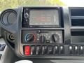 Dashboard interface of a 2020 Hino 155 featuring a touchscreen display radio controls air conditioning dials and various buttons