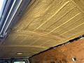 The interior ceiling of a 2012 Chevrolet Express van featuring a textured insulation material applied across the surface