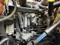 Close-up of a 2011 International 4400 engine showing various components including fuel injectors pipes and hoses
