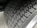 Close-up of a heavy-duty tire with a deep tread pattern designed for traction and stability on a 2014 Hino 195 vehicle