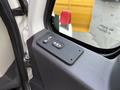 A door control panel of a 2016 International 7400 featuring buttons for power window and lock functions