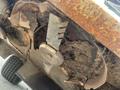 A rusted blade assembly from a 2012 Toro Groundsmaster 5910 showing significant wear and buildup of dirt and debris