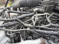 Close-up view of the engine components of a 2017 Hino 338 featuring various hoses and connectors intertwined with black wiring harnesses