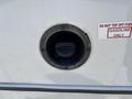 A fuel filler neck for a 2020 Chevrolet Express with a circular opening and a cap labeled gasoline only