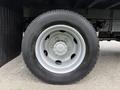 Close-up of a silver wheel with a tire labeled 195 mounted on a truck axle