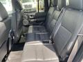 Interior view of a 2006 Land Rover LR3 showing a spacious black leather back seat area with seating for three passengers and door panel detailing