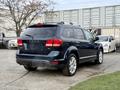 A 2013 Dodge Journey SUV parked with a rear view highlighting its sleek design and alloy wheels