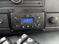 A control panel inside a 2020 Chevrolet Express featuring buttons for various settings and a digital clock displaying 03:15