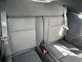 Interior view of the back seats of a 2005 Chrysler PT Cruiser with black fabric upholstery and seatbelts