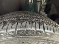 Close-up of a 2020 Lincoln Corsair tire showing tread pattern with water droplets and dirt specks on the surface