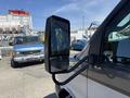 A 2019 Chevrolet Express van with a side mirror prominently displayed in the foreground